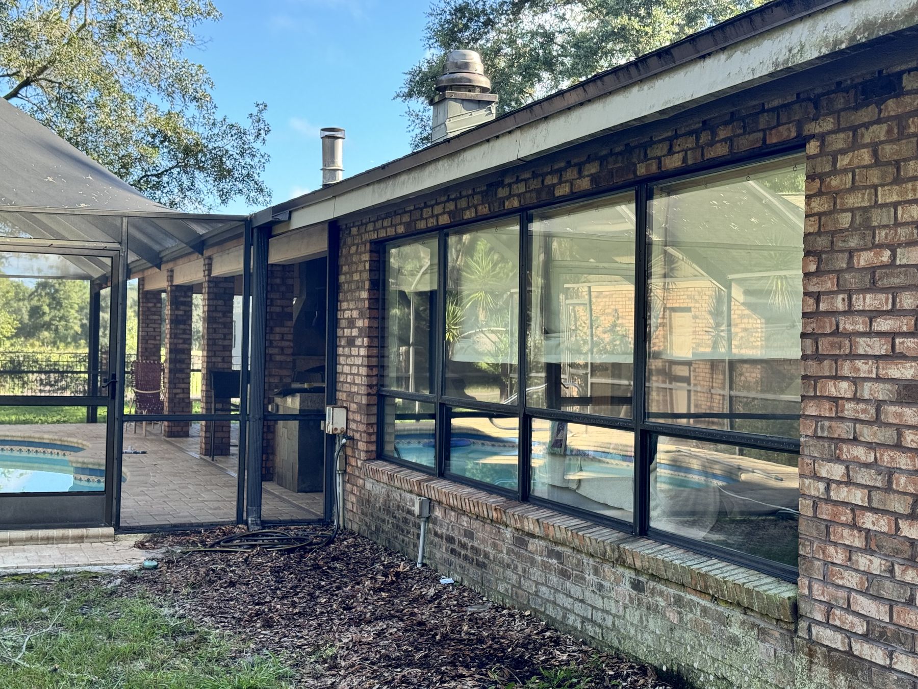 Poolside picture windows on a brick home
