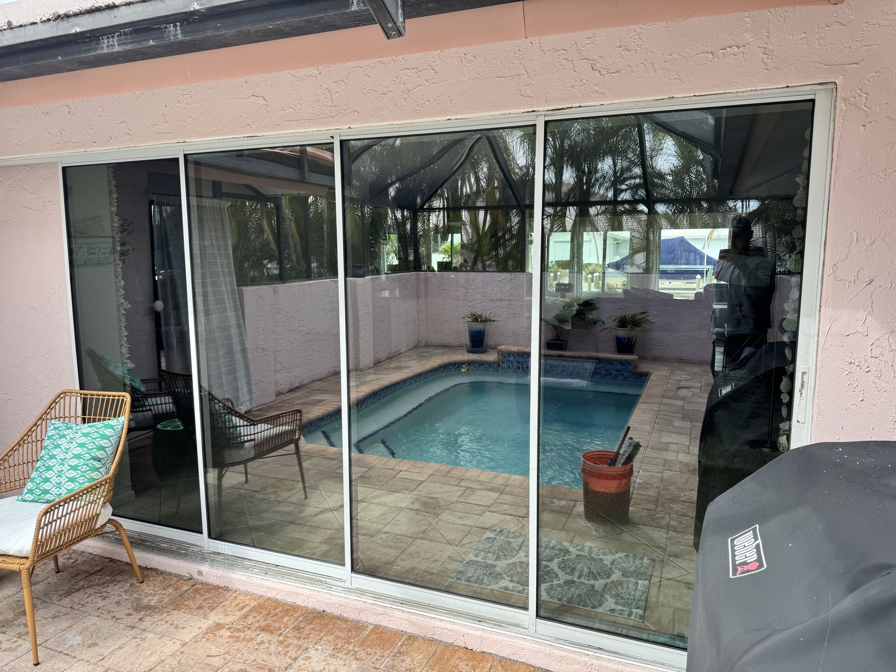 Sliding glass doors looking out onto a screened pool lanai