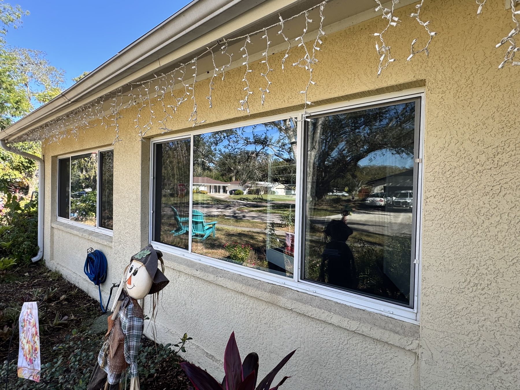 Picture windows along the front of a ranch-style home